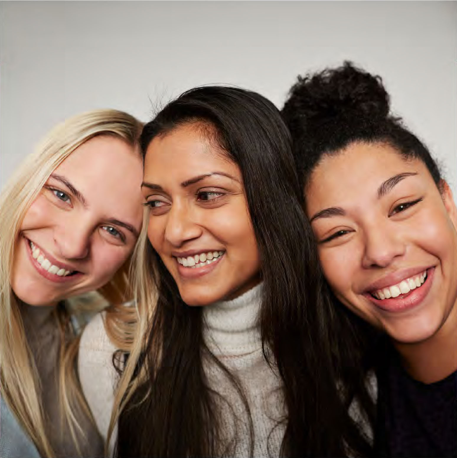 3 women hugging and smiling