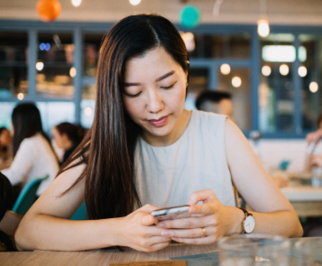 A woman looking down at her phone